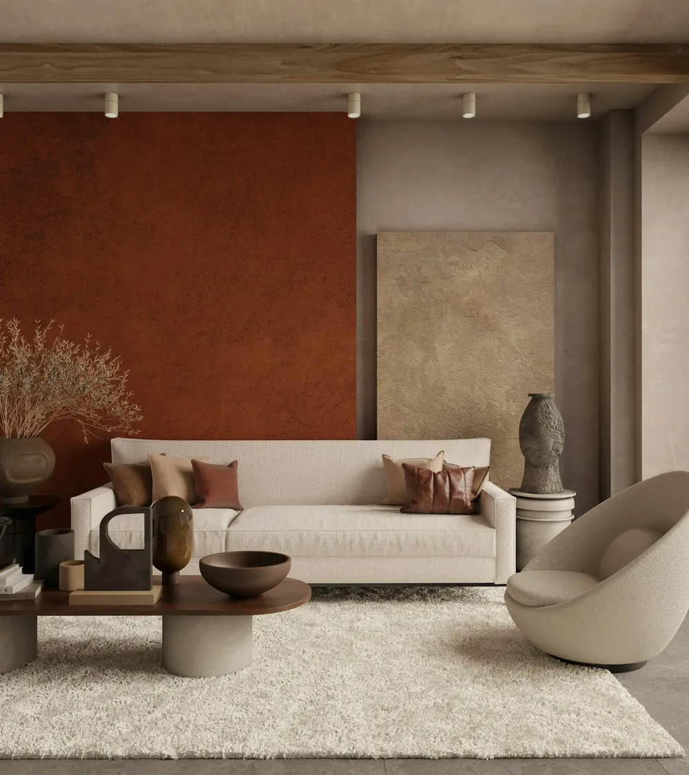 A warm living room with a terracotta feature wall, a cream sofa and a sculptural armchair